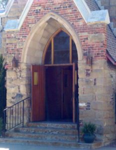 Pueblo Divine Science Center - Church exterior: front entry, looking in showing church doors